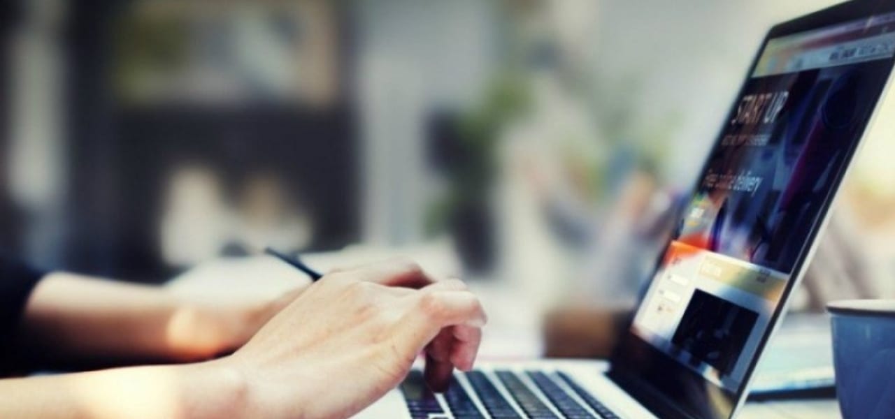 hands typing on a laptop computer