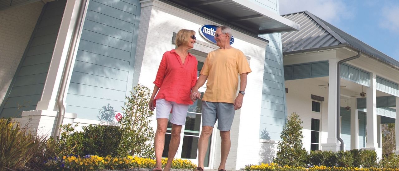 Couple outside of a community sales gallery