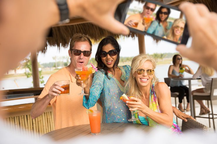 group of friends with drinks at outdoor bar